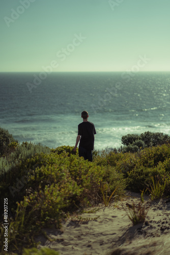 person looking upon the ocean
