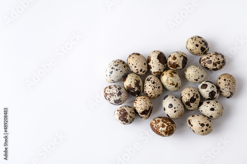 quail eggs on white background. Top view. Home cooking. The idea of healthy breakfast, symbol of Easter. Copy space