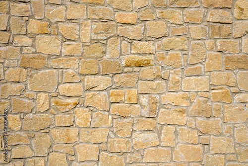 Texture of natural yellow stone brick wall