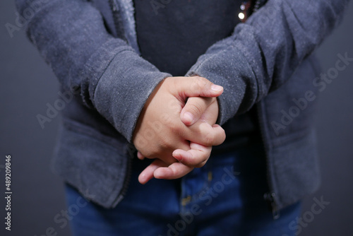 Close up of nervous child hand on black 