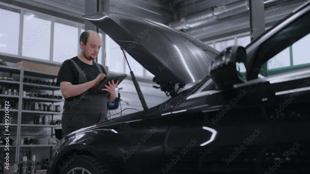 custom made wallpaper toronto digitalMale Mechanic Uses a Tablet Computer with an Augmented Reality Diagnostics Software. Specialist Inspecting the Car in Order to Find Broken Components Inside the Engine Bay. Modern Car Service.