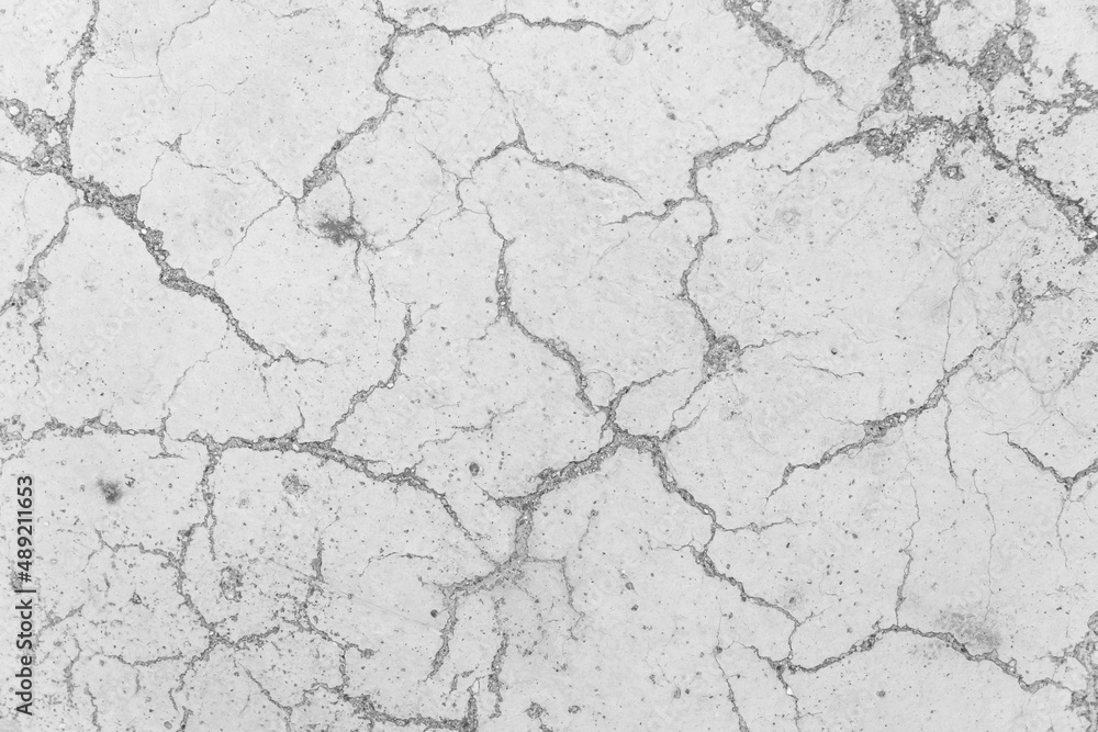 Cracks on white concrete surface cracked weathered cement worn texture broken abstract damaged pattern background Cracks on white concrete surface cracked weathered cement worn texture broken abstract damaged pattern background
