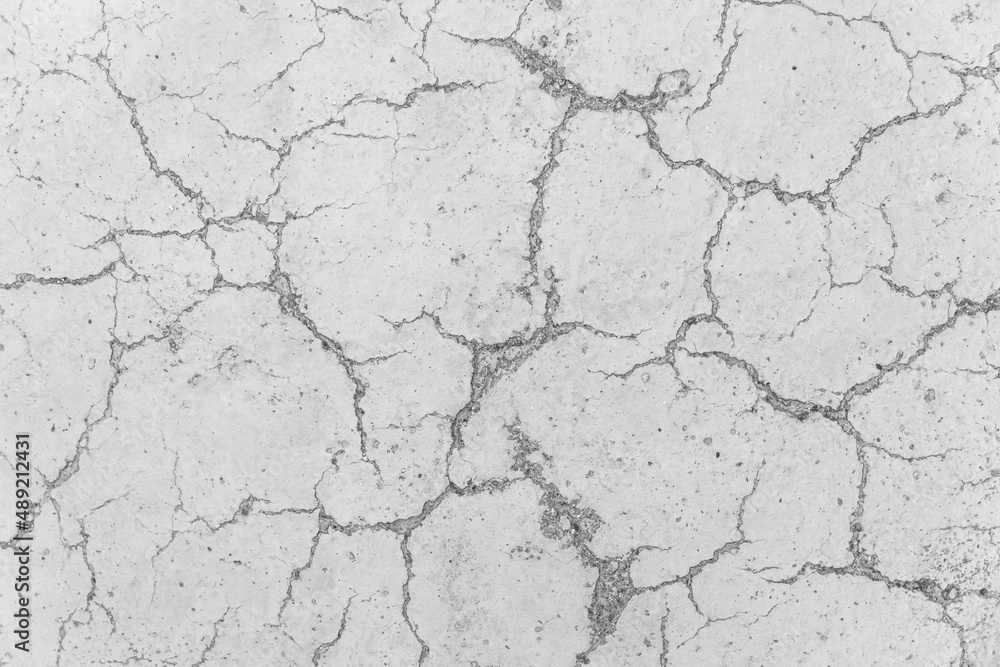 Cracks on white concrete surface cracked weathered cement worn texture broken abstract damaged pattern background Cracks on white concrete surface cracked weathered cement worn texture broken abstract damaged pattern background