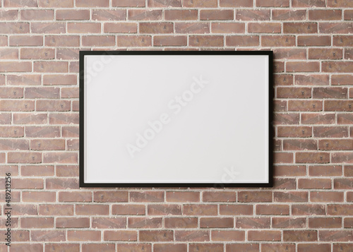 Blank, black horizontal picture frame hanging on brown brick wall. Template, mock up for your picture or poster. Copy space. 3D rendering.