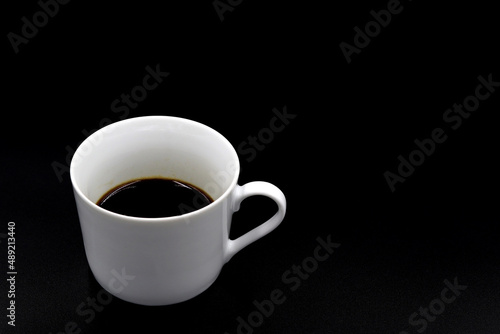 Coffee cup on a black background  in the center for copy space