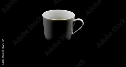 Coffee cup on a black background, in the center for copy space
