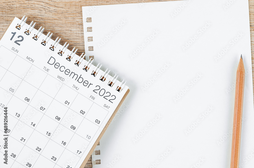 Fototapeta premium December 2022 desk calendar with blank paper sheet for your text or message on wooden background.