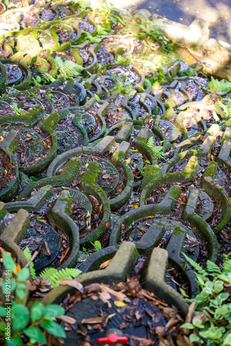 The flowing water sculpture landscape composed of many stone grinding discs in the park photo