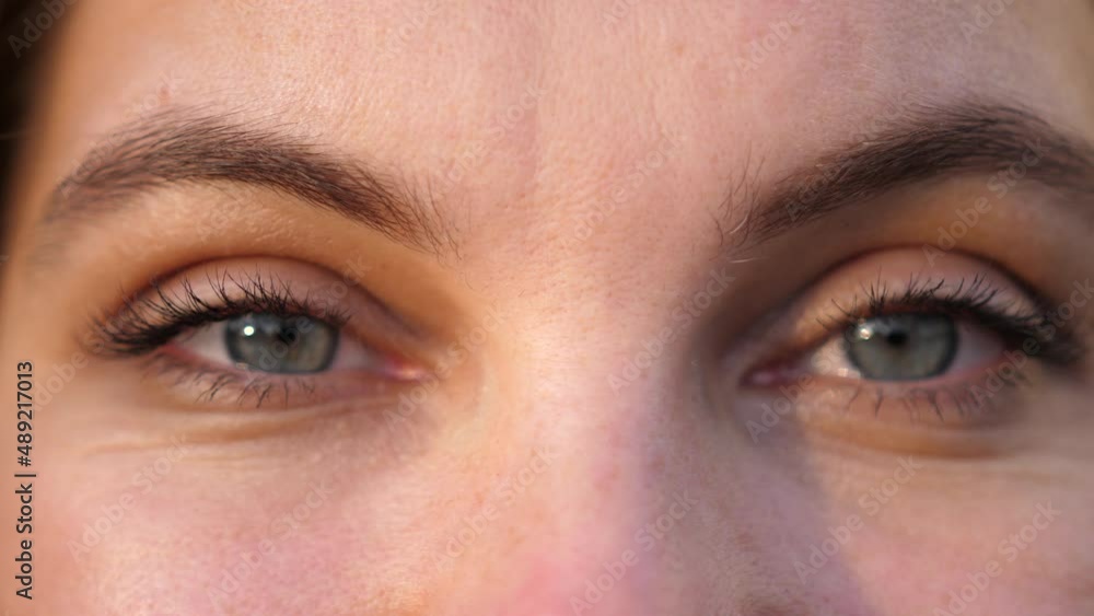 A close up portrait of beauty young beautiful woman's eyes, smiling looking at camera. A close up portrait of beauty young beautiful woman's eyes, smiling looking at camera.