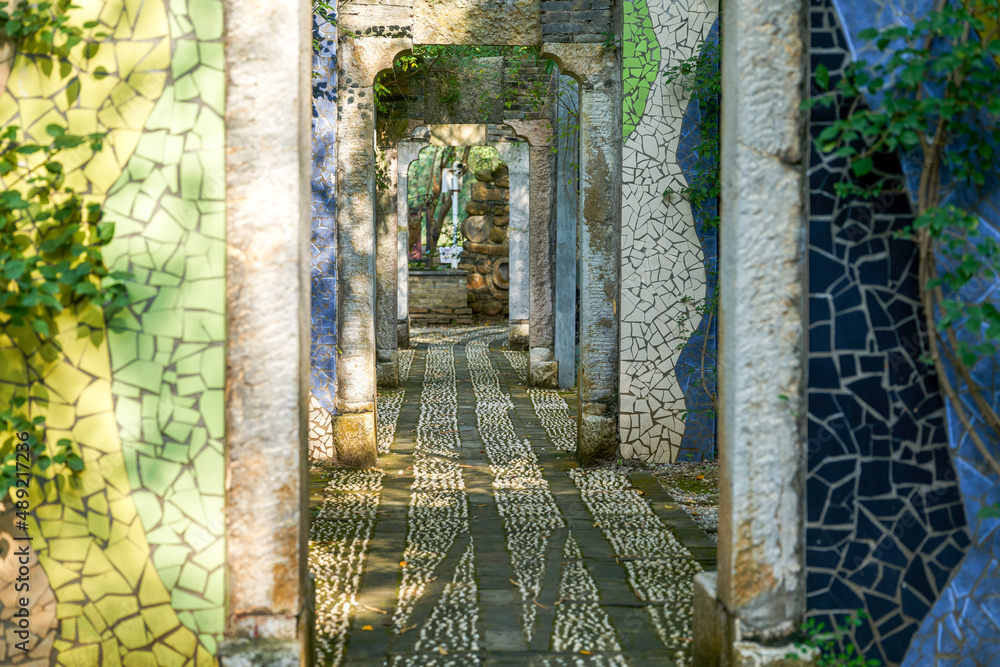 Wall and stone arches decorated with colorful broken tiles
