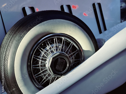 Closeup of a white sidewall tire with the light blue background photo