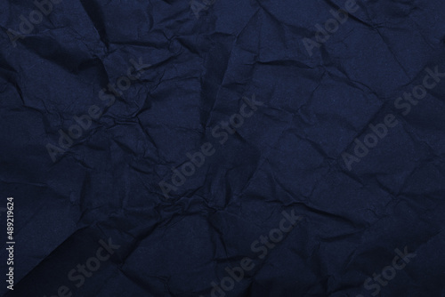 Dark blue crumpled rough paper making a background