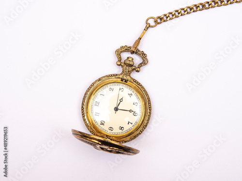 Ancient pocket watch isolated on white with golden chain