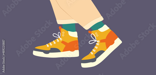 Shoe, footwear. Basketball shoes. Sport shoes. Color high-top sneakers. Feet legs walking in high top sneakers with colored socks and trousers. Lace-up shoes. Color Isolated flat vector illustration   photo