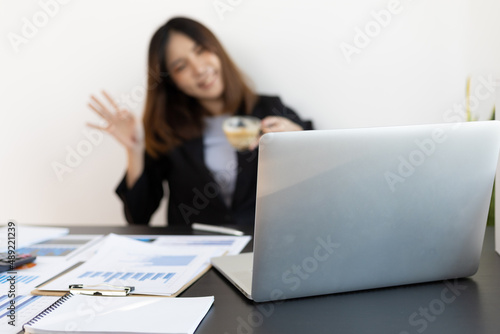Online meeting concept. Businesswoman working on laptop and gesturing to greet colleagues online meeting.