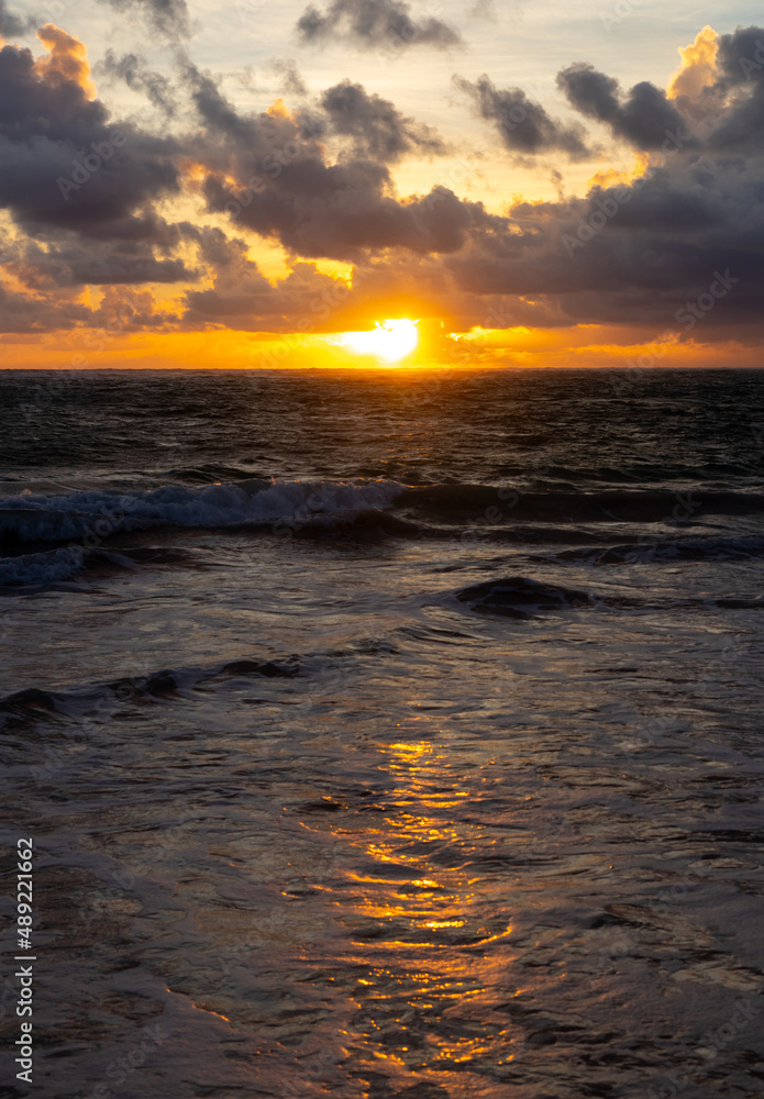 Scenic gold sunrise above the ocean in the Dominican Republic.