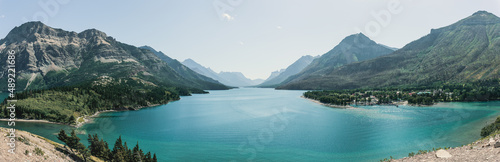 Panoramic view of the Waterton Park with canyon mountains, lake water against a light sky, Canada photo