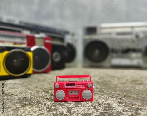 Boombox toy with real boomboxes background retro style