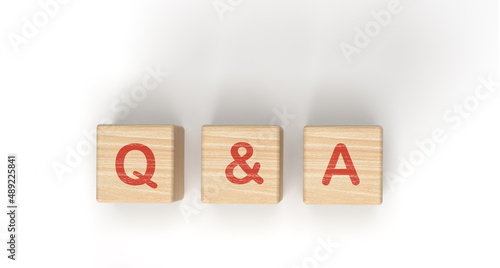 Q&A - questions and answers words written on wooden blocks This text is written in red letters and shadows on a white background. business idea for your design