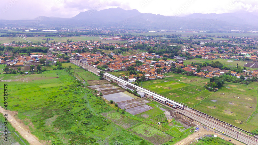 Aerial view of the railway station rail surrounded by rice fields in the Rancaekek area, Indonesia