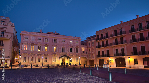 Night view of famous square Place du Palais in the historic center of Monaco (Monaco-Ville) at the French Riviera after sunset with old buildings.