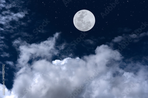 Full moon with clouds on sky.