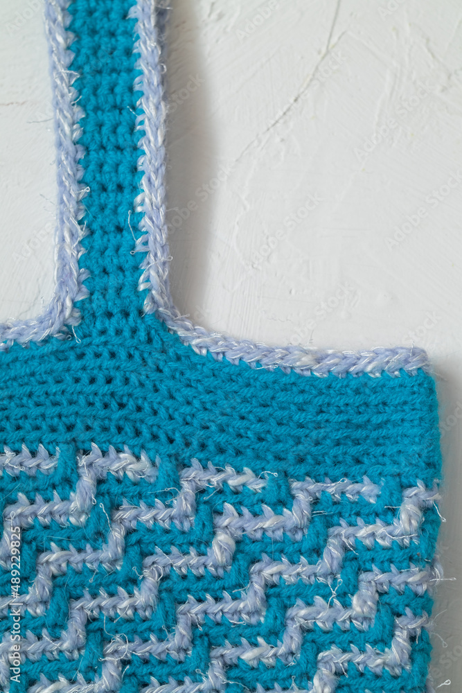 Blue white crochet bag for shopping. Eco friendly crochet bag with mosaic geometric pattern. Zero waste concept. Blue white crochet bag for shopping. Eco friendly crochet bag with mosaic geometric pattern. Zero waste concept.