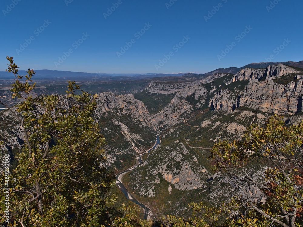 Beautiful panoramic view of famour canyon Verdon Gorge (Gorges du Verdon) in Provence, southern France in autumn with limestone rocks and trees.