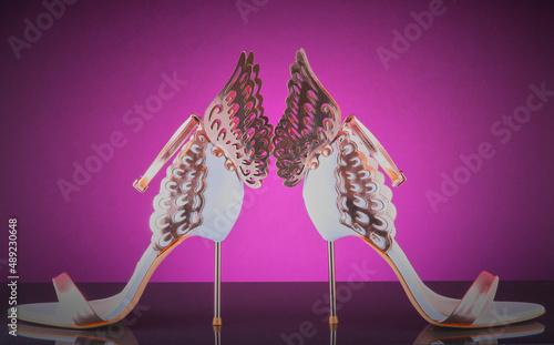 Ladies fashionable high heel shoes on a vibrant background. photo
