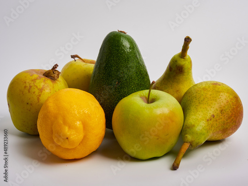 fruits pear apple lemon avocado on white background