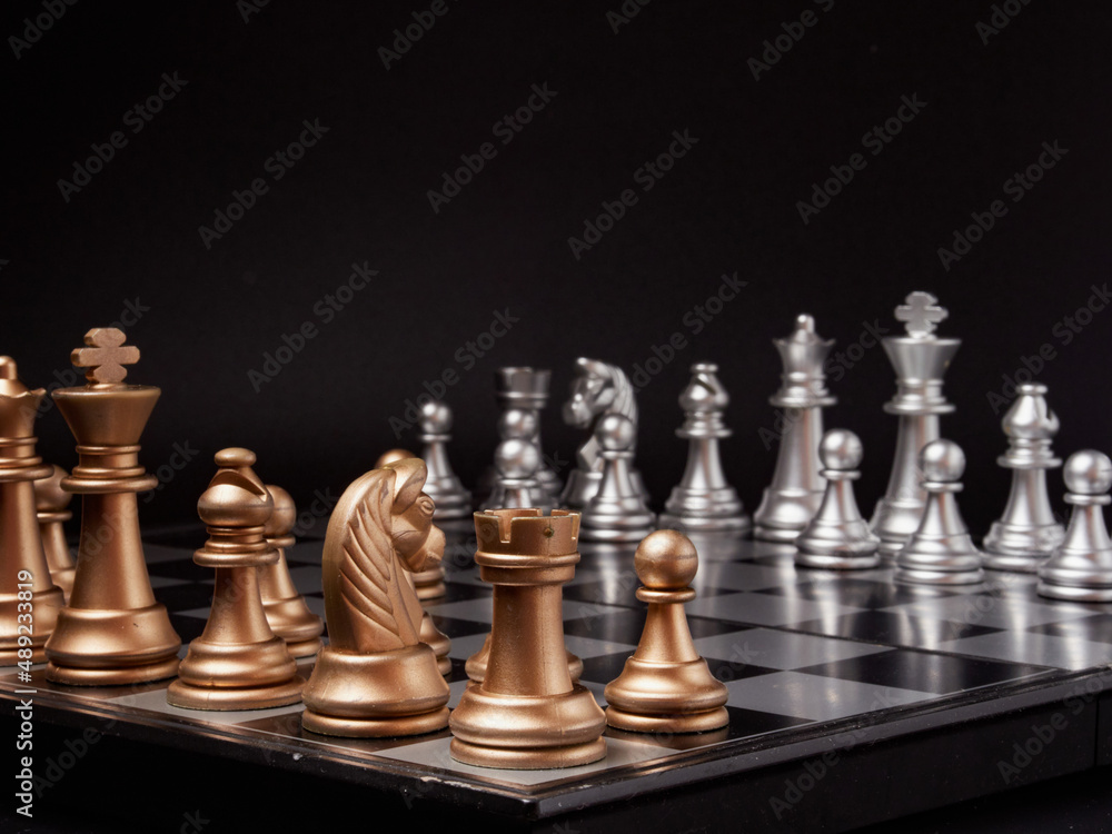 One chess piece stands against a full set of chess pieces. The concept of strategy, planning and decision-making One chess piece stands against a full set of chess pieces. The concept of strategy, planning and decision-making