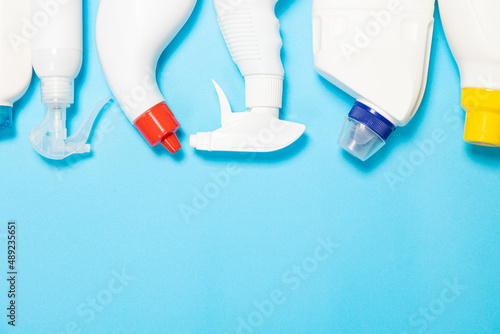 white bottles of cleaning agent on a blue background on the side. Professional cleaning products, general cleaning. Household chemicals top view