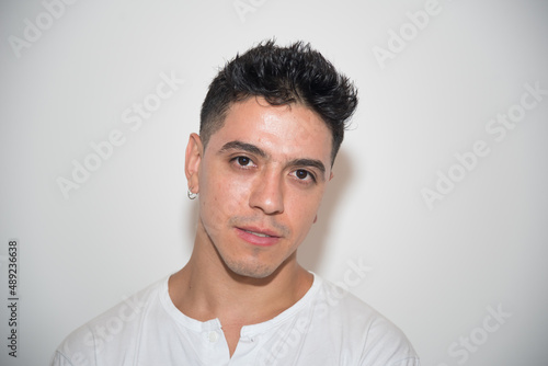 nice guy, dark-haired, white test, white t-shirt, looking straight ahead, neutral background