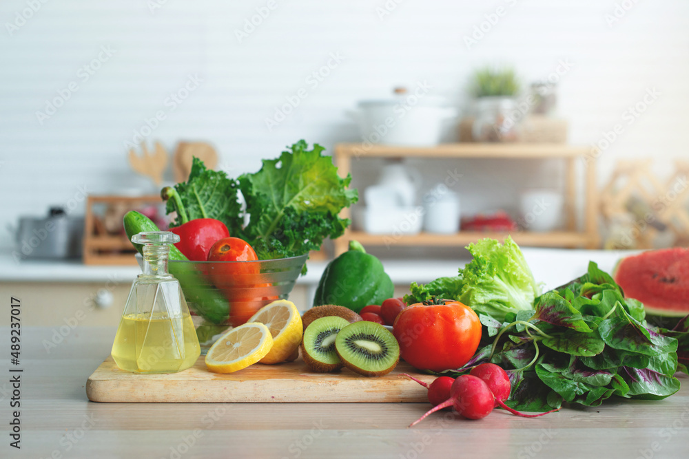 Fresh fruits and vegetables on wooden table in bright white kitchen, healthy lifestyle concept Fresh fruits and vegetables on wooden table in bright white kitchen, healthy lifestyle concept