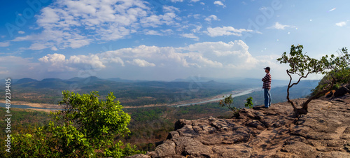 Tourists watch the atmosphere, sky and clouds above the Mekong mountain at Pha Chanadai. Ubon Ratchathani, Thailand photo