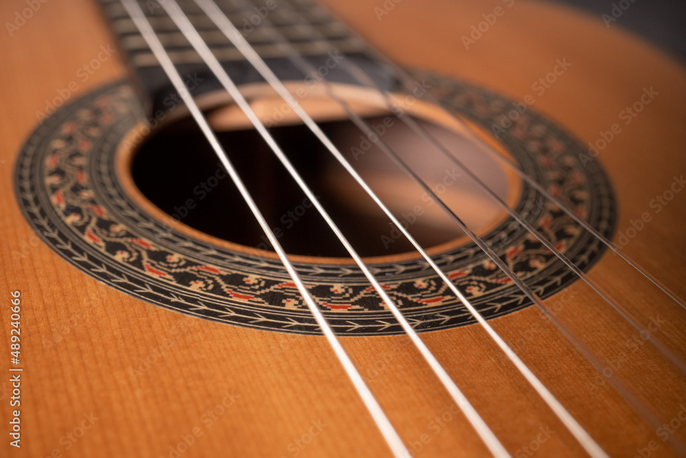 Classical guitar on black background. Acoustic guitar concept.Perfect for flyer, card, poster or wallpaper Classical guitar on black background. Acoustic guitar concept.Perfect for flyer, card, poster or wallpaper
