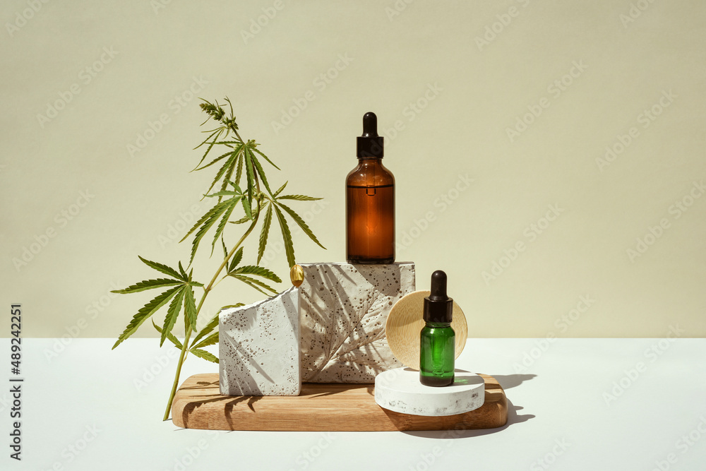 CBD oil, cannabis setting in different bottles and marijuana leaf