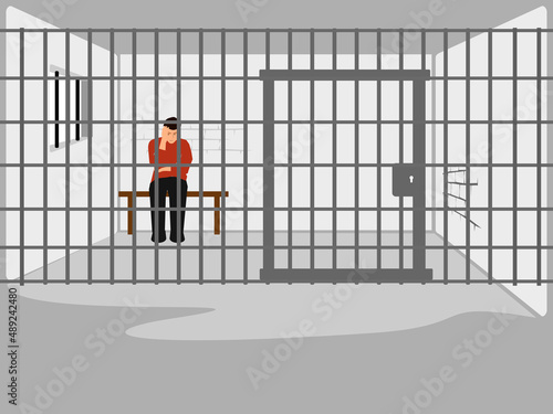 man sitting stressed in a prison cell with iron bars in the background