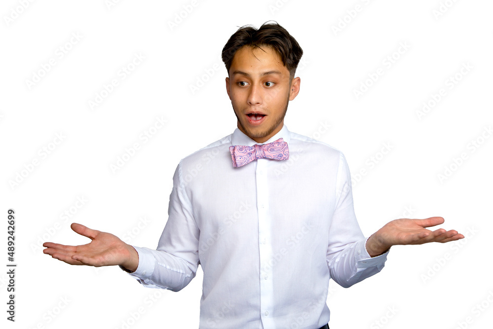 Latin man with surprised expression wearing pink bow tie and white shirt against a white background Latin man with surprised expression wearing pink bow tie and white shirt against a white background