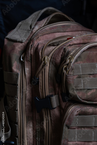 Military backpack of khaki color. Camouflage backpack. Military equipment is special, close up