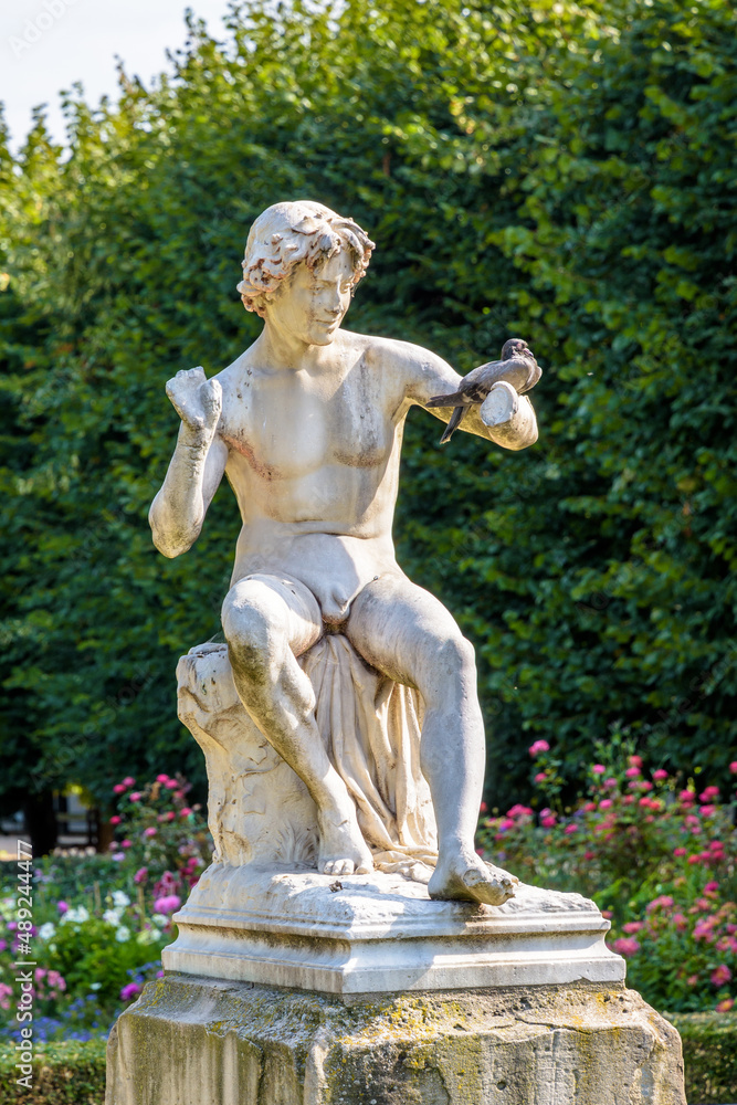 The Snake Charmer statue in the Palais-Royal garden in Paris, France. The Snake Charmer statue in the Palais-Royal garden in Paris, France.