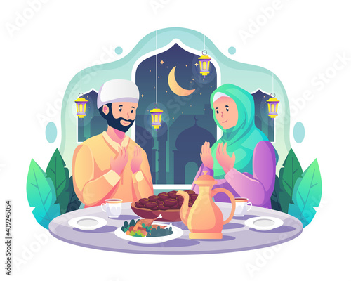 Muslim couple praying before having iftar after fasting during Ramadan Kareem Mubarak. food and dates on the table. Flat style vector illustration