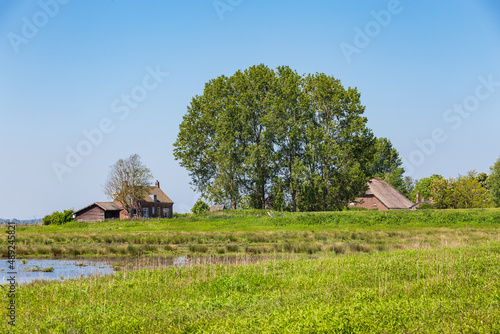 Landscape with farm house and shed of island and nature reserve Tiengemeten Hoeksche Waard n South Holland in The neteherlands photo