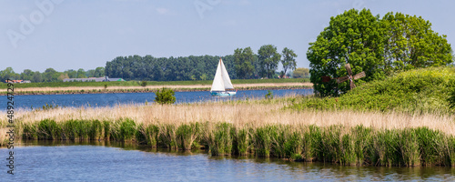 Landsacape with sailing boat of island and nature reserve Tiengemeten Hoeksche Waard n South Holland in The neteherlands photo