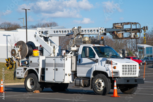 Εκτύπωση καμβά Front and side view of parked communication utility trucks in residential neighb