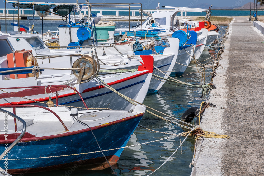 Fishing boat anchored at Elafonisos island port Greece. Blue sky background. Sunny summer day Fishing boat anchored at Elafonisos island port Greece. Blue sky background. Sunny summer day