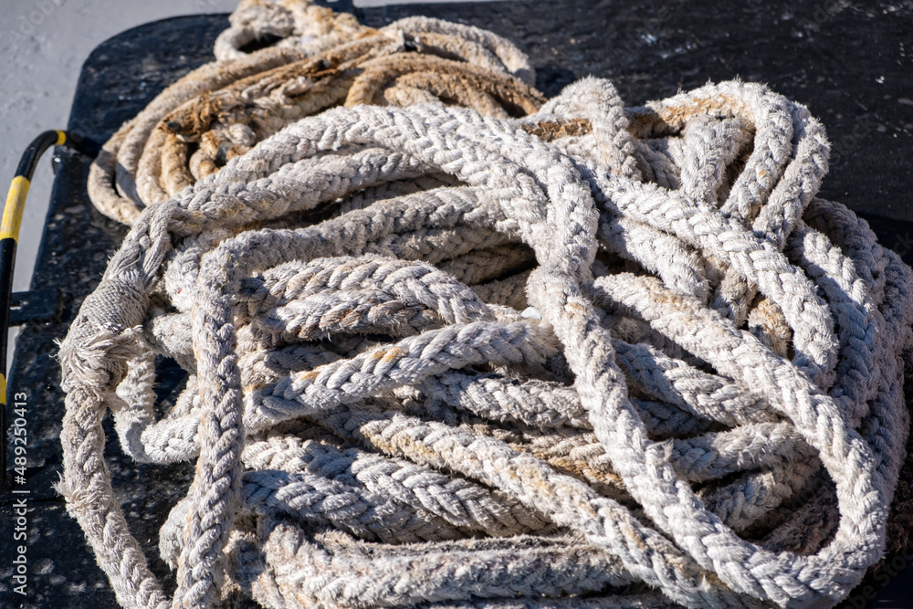 Boat rope old worn out, rope for ship mooring in the port, overhead closeup view