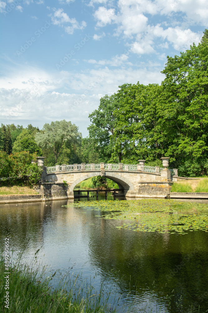 The view of the 19th century stone Visconti bridge over the Slavyanka River in summertime in Pavlovsky Park, Saint Petersburg, Russia The view of the 19th century stone Visconti bridge over the Slavyanka River in summertime in Pavlovsky Park, Saint Petersburg, Russia