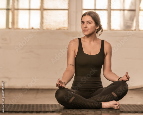 Young yogi practices asanas in an industrial setting
