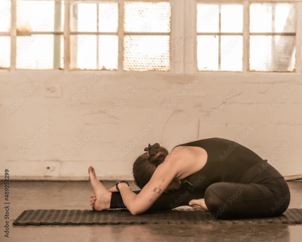 Young yogi practices asanas in an industrial setting Young yogi practices asanas in an industrial setting